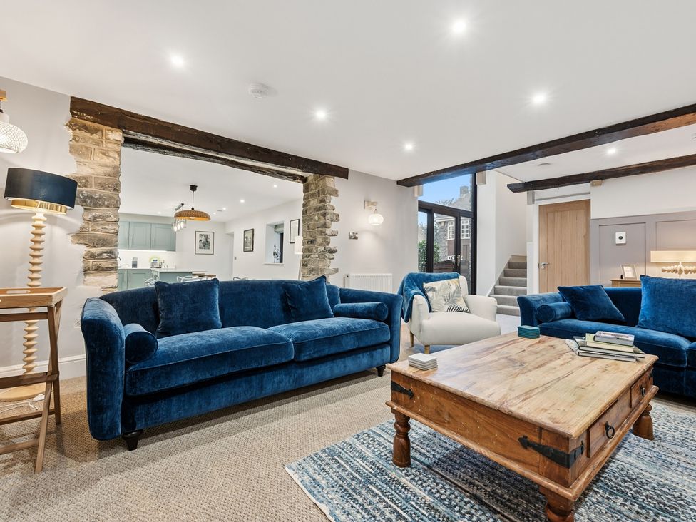 A living room with sofas and a coffee table at The Forge in Castleton, Peak District