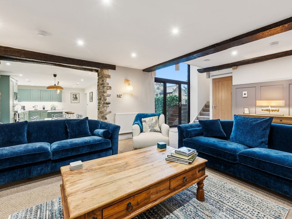 A living room with sofas and a coffee table at The Forge in Castleton, Peak District