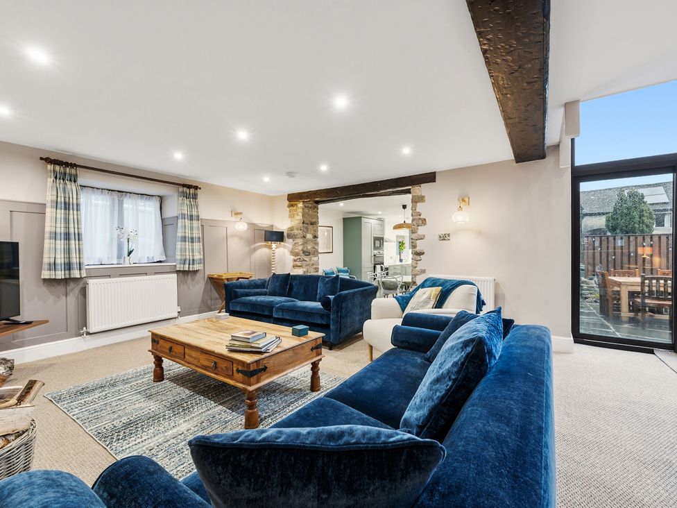 A living room with a sofa and coffee table at The Forge in Castleton, Peak District