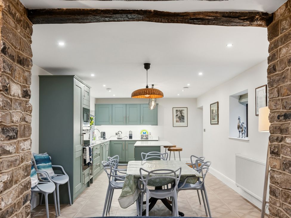 A kitchen with a dining table and chairs at The Forge in Castleton, Peak District