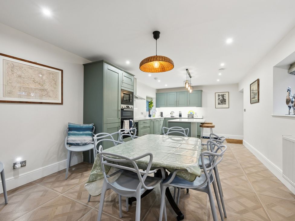A kitchen with a dining table and chairs at The Forge in Castleton, Peak District