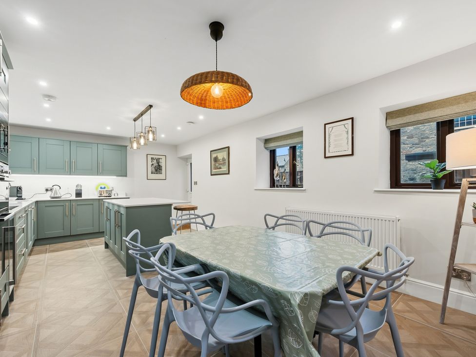 A kitchen with a dining table and chairs at The Forge in Castleton, Peak District