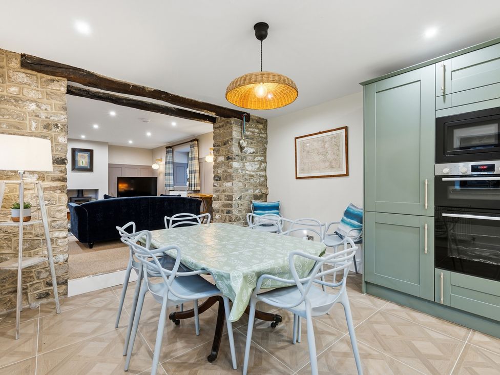 A dining area with a table and chairs at The Forge in Castleton, Peak District