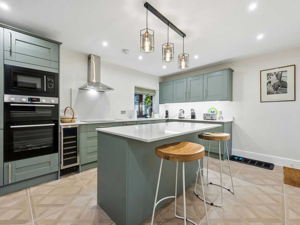 A kitchen with cabinets and appliances at The Forge in Castleton, Peak District
