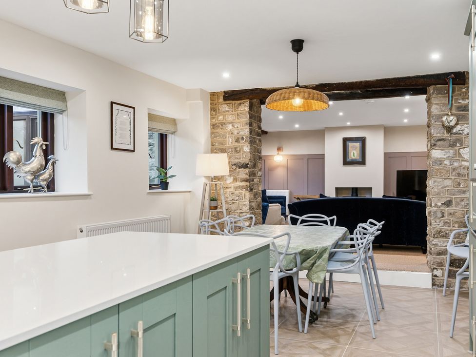 A kitchen with a table and chairs at The Forge in Castleton, Peak District