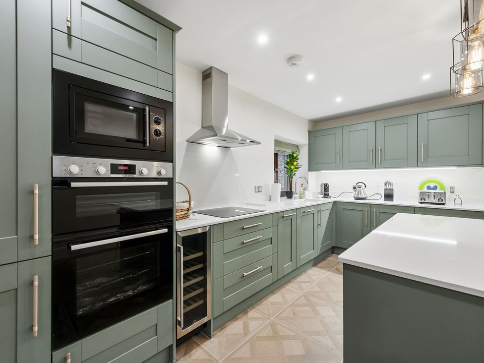 A kitchen with ovens and a sink at The Forge in Castleton, Peak District