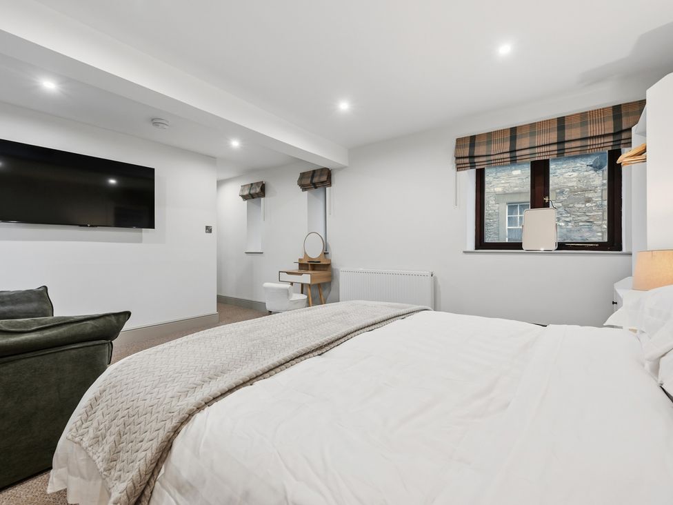 A bedroom with a bed and television at The Forge in Castleton, Peak District