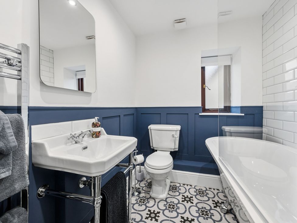 A bathroom with a sink, toilet, and bathtub at The Forge in Castleton, Peak District