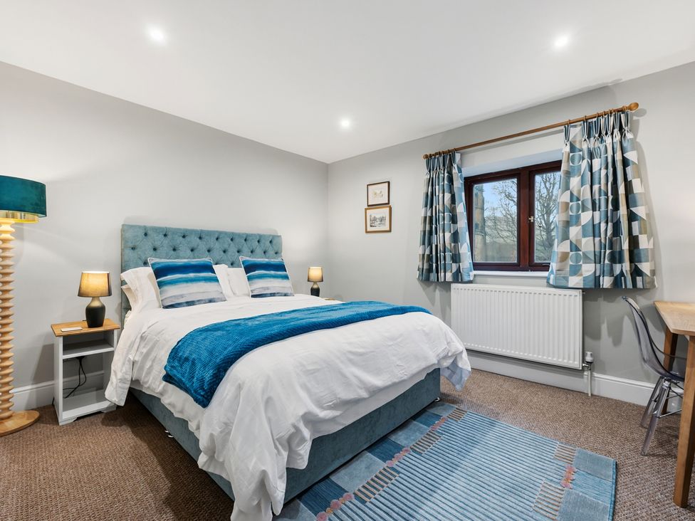 A bedroom with a bed and bedside table at The Forge in Castleton, Peak District