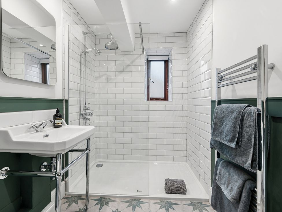 A bathroom with a shower and sink at The Forge in Castleton, Peak District