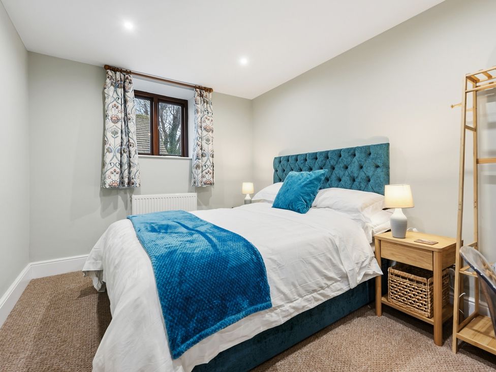 A bedroom with a bed and bedside table at The Forge in Castleton, Peak District