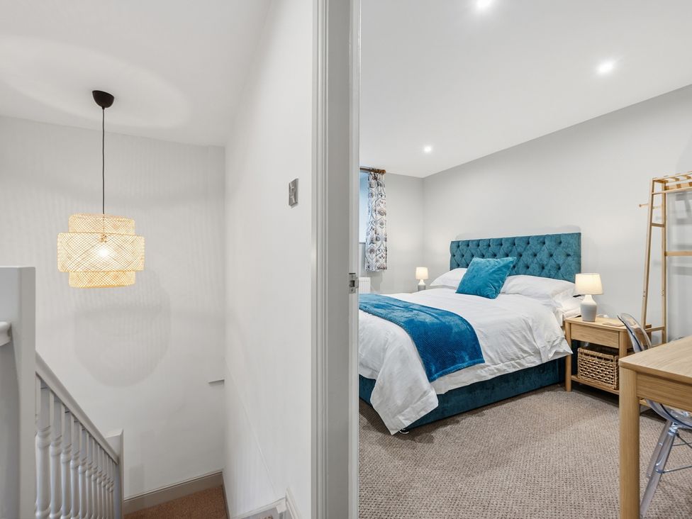 A bedroom with a bed and desk at The Forge in Castleton, Peak District