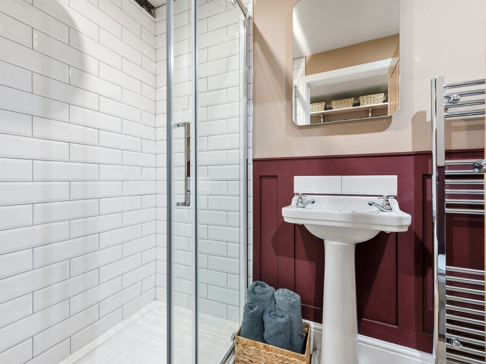 A bathroom with a shower and wash basin at The Forge in Castleton, Peak District