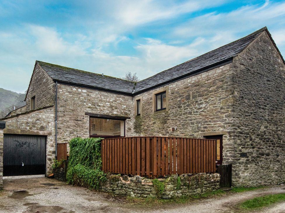 A building with stone walls and windows at The Forge in Castleton, Peak District