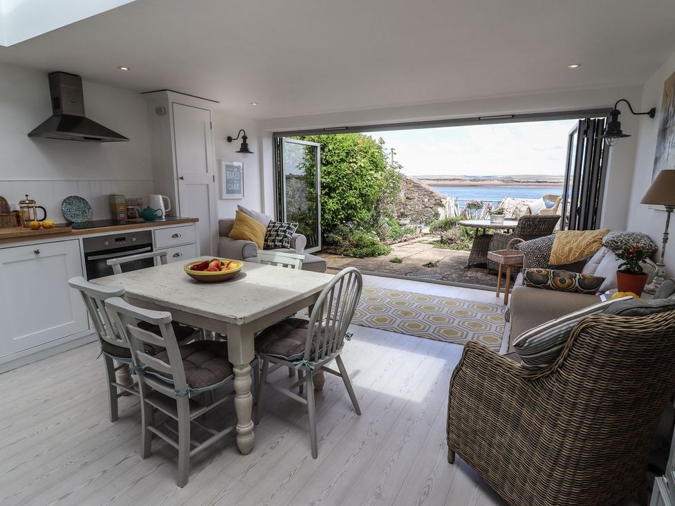 A kitchen with dining table and chairs at Mariners Cottage in Bideford