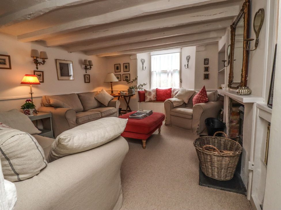 A living room with a sofa and two lamps at Mariners Cottage in Bideford