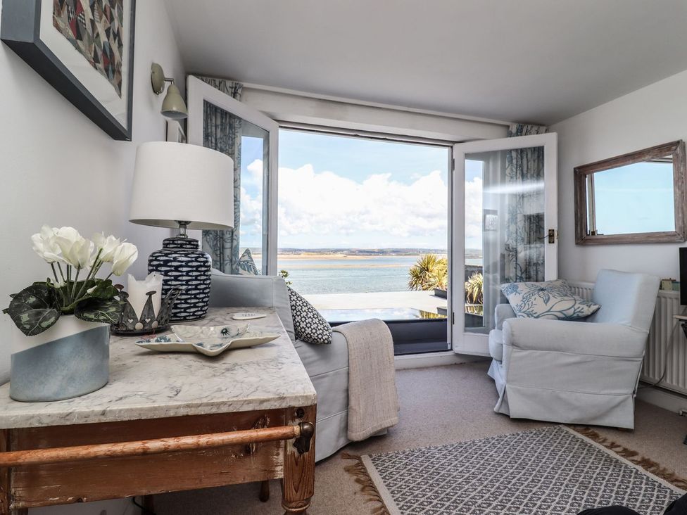 A living room with a view of the water at Mariners Cottage in Bideford