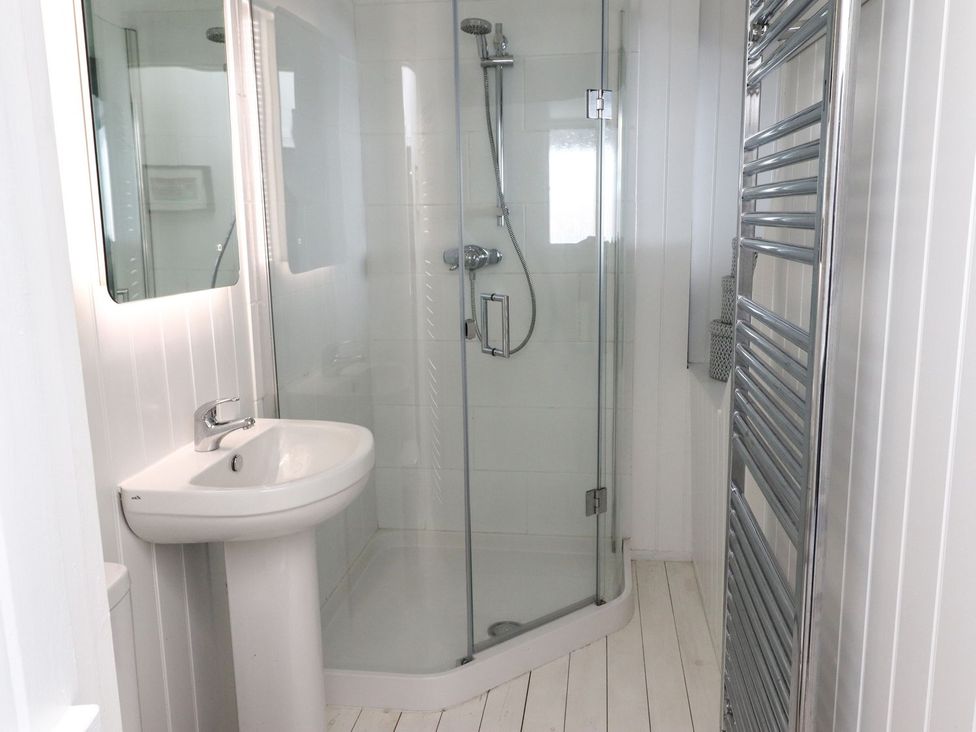 A bathroom with a shower and sink at Mariners Cottage in Bideford