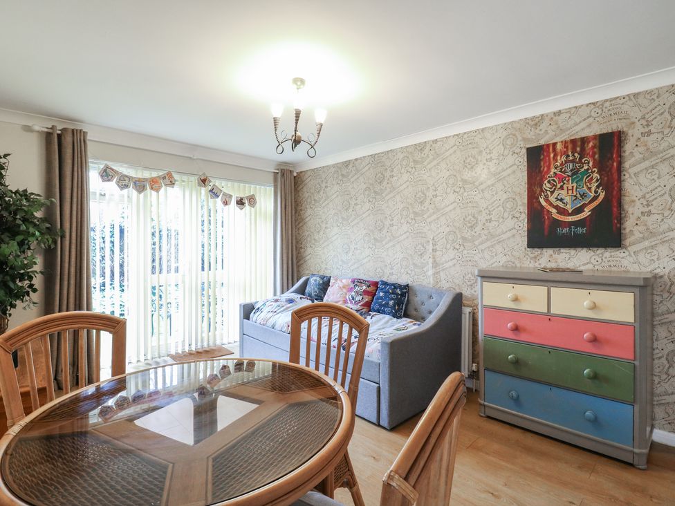 A dining room with a table and chairs at Wizard's Hideaway in Watford