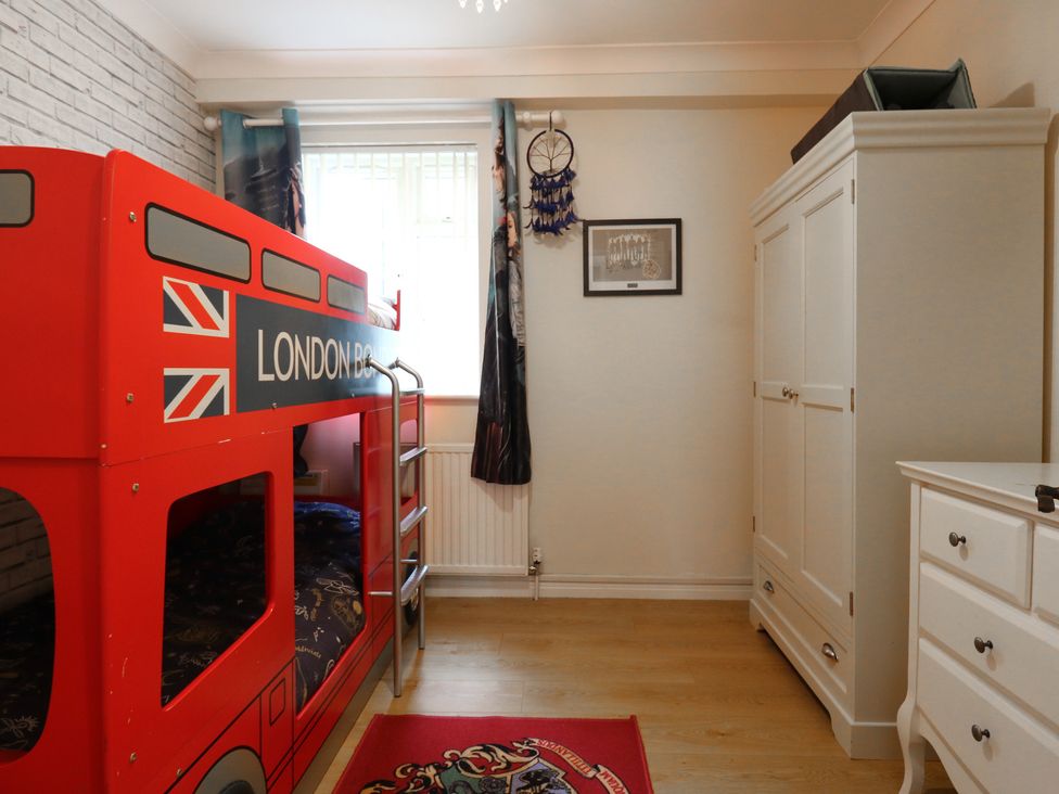 A bedroom with a bunk bed and wardrobe at Wizard's Hideaway in Watford