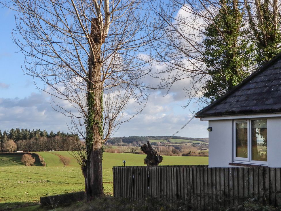 A view of a tree and house near a field at The Old Telephone Exchange Exeter
