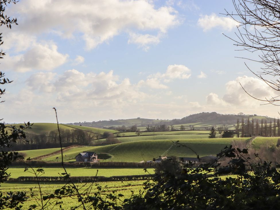 A view of fields and a house surrounded by trees at The Old Telephone Exchange in Exeter