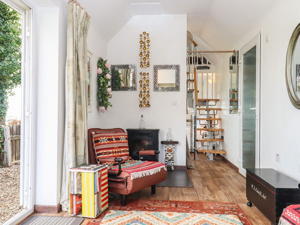 A snug with a chair and stairs at The Old Telephone Exchange in Exeter
