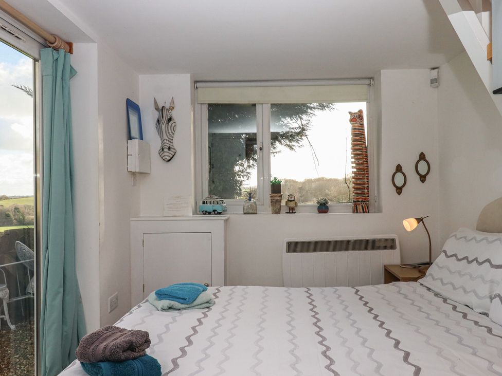 A bedroom with a bed and decorative items at The Old Telephone Exchange in Exeter