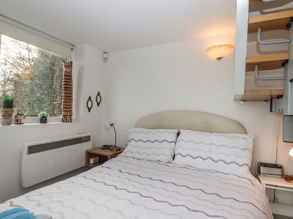A bedroom with a bed and decorative items at The Old Telephone Exchange Exeter