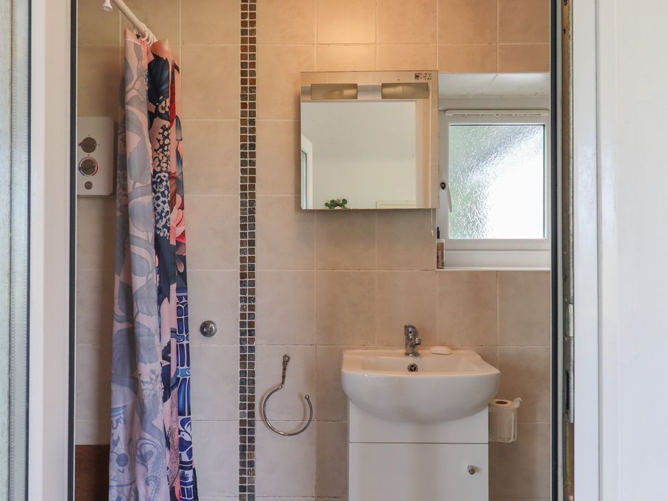 A bathroom with a shower and sink at The Old Telephone Exchange in Exeter