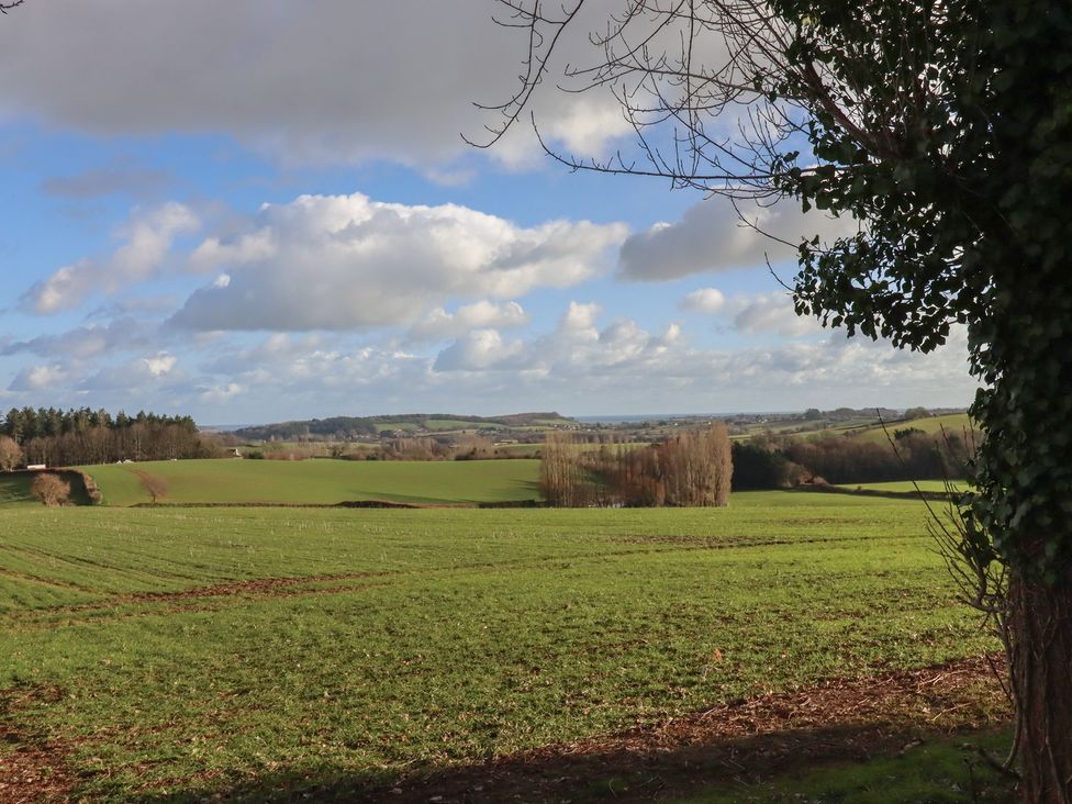 A view of fields and trees with clouds in the sky at The Old Telephone Exchange Exeter
