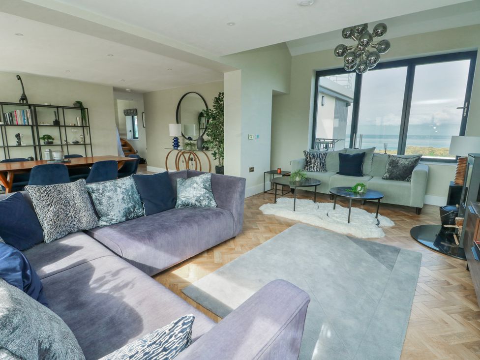 A living room with a sofa and coffee table at Pengarnedd in Amlwch