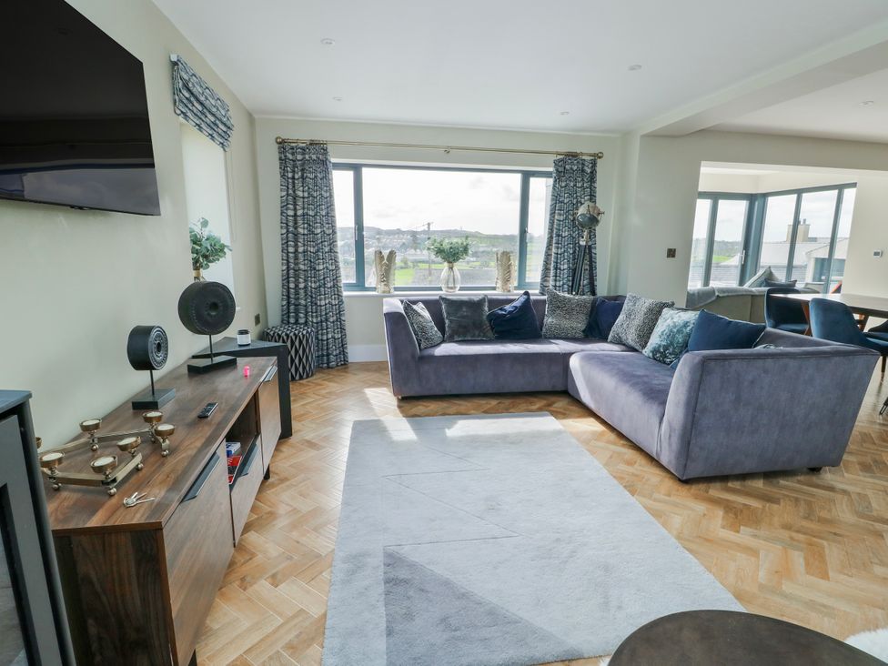 A living room with a sofa and TV at Pengarnedd in Amlwch