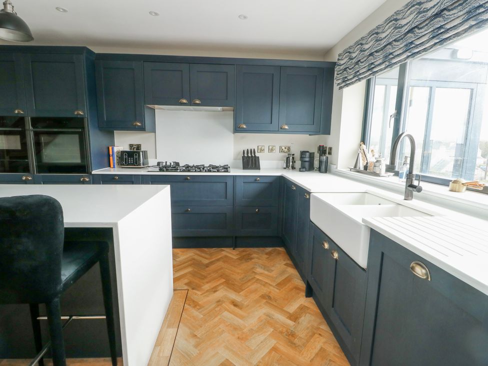 A kitchen with cabinets and a sink at Pengarnedd in Amlwch