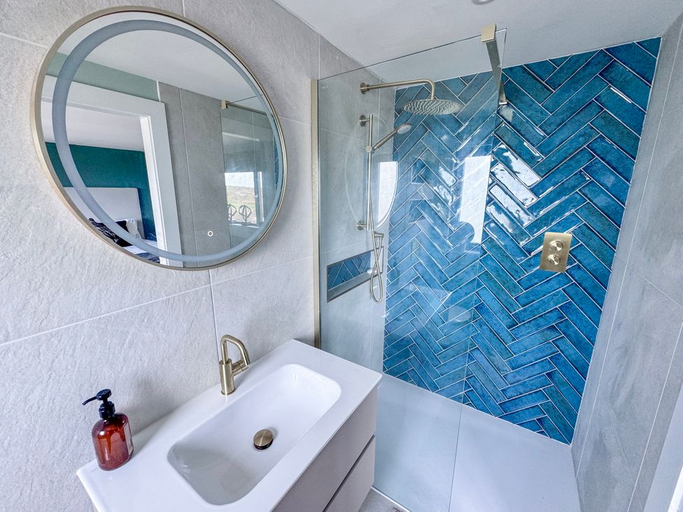 A bathroom with a shower and sink at Pengarnedd in Amlwch
