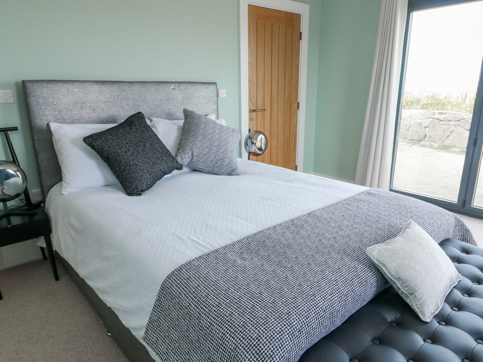 A bedroom with bed and pillows at Pengarnedd in Amlwch