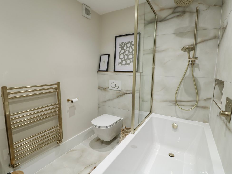 A bathroom with a bathtub and shower at Pengarnedd in Amlwch