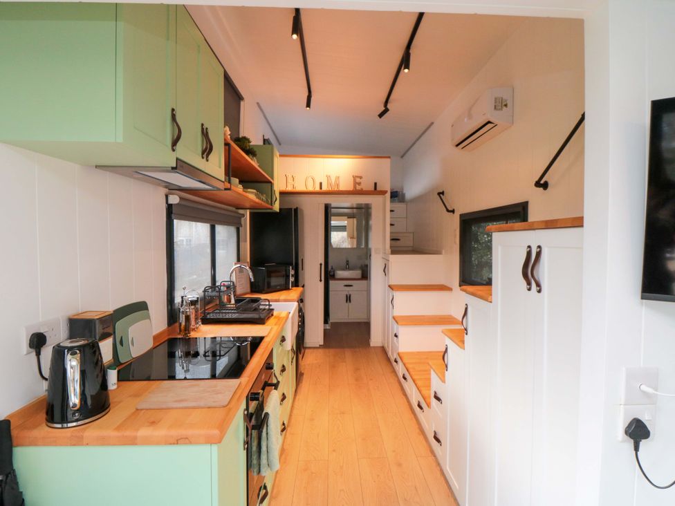 A kitchen with countertop and cabinets at The Tiny Home
