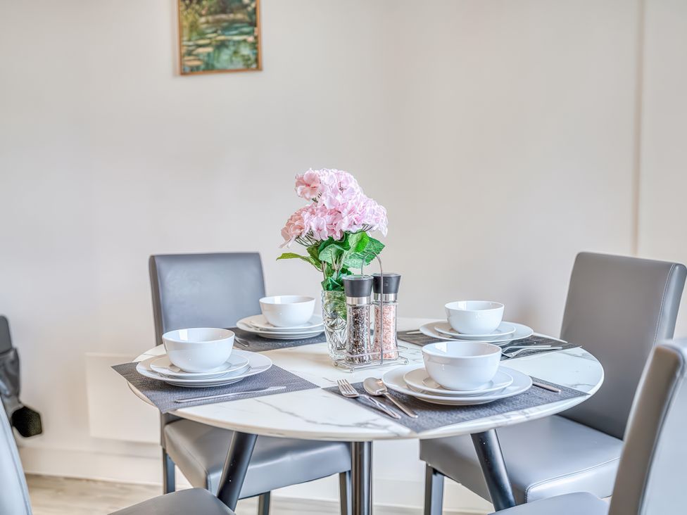 A dining room with a table set for meals at Apartment 422 Manchester