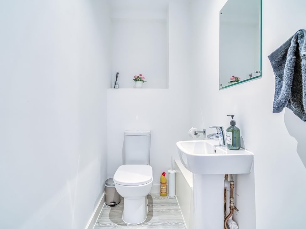 A bathroom with a toilet and sink at Apartment 422 in Manchester
