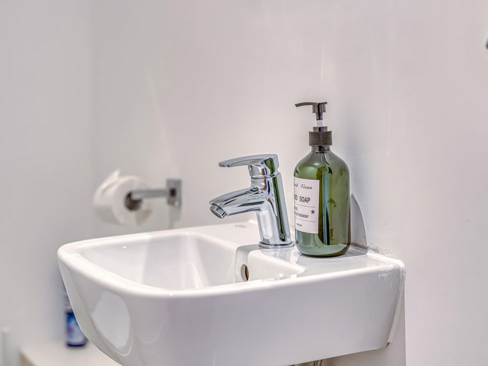 A sink with a tap and soap dispenser at Apartment 422 in Manchester