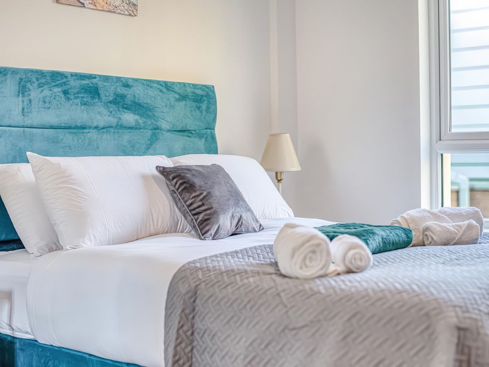 A bedroom with a bed and pillows at Apartment 422 in Manchester