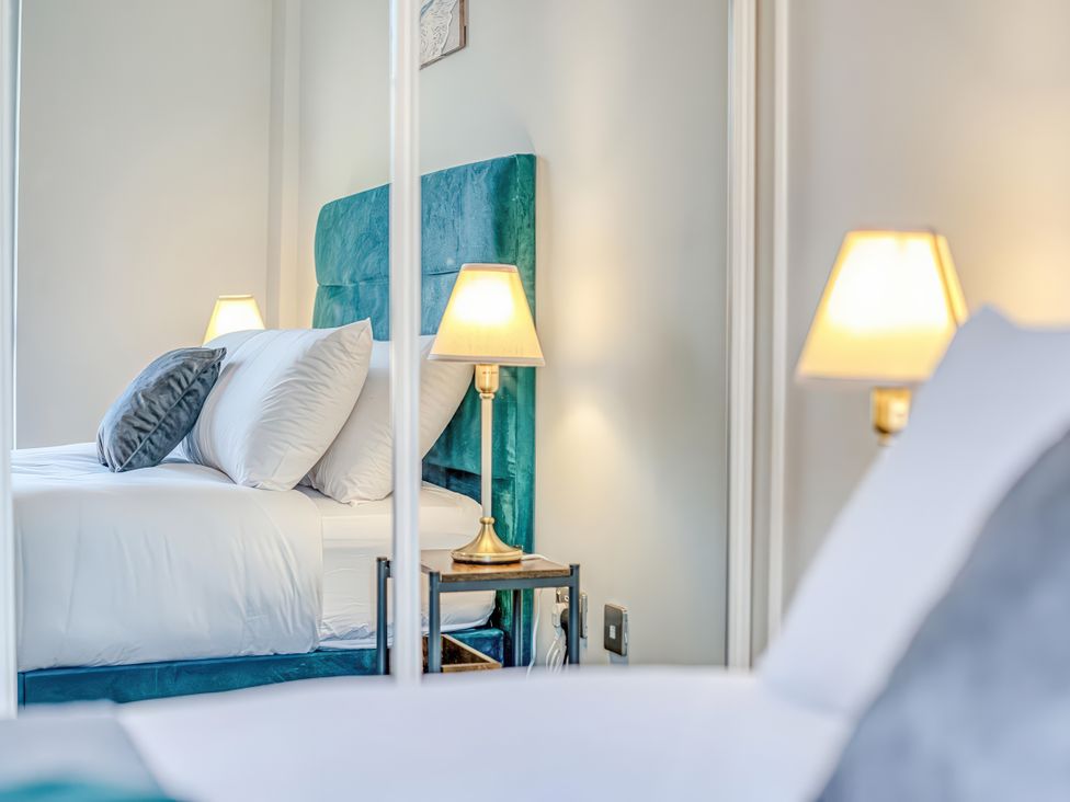 A bedroom with a bed and nightstand at Apartment 422 in Manchester