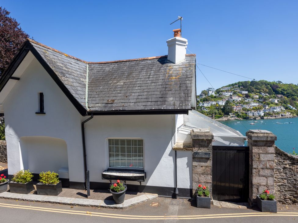 An exterior view of a house with a garden at Bell Cottage in Dartmouth