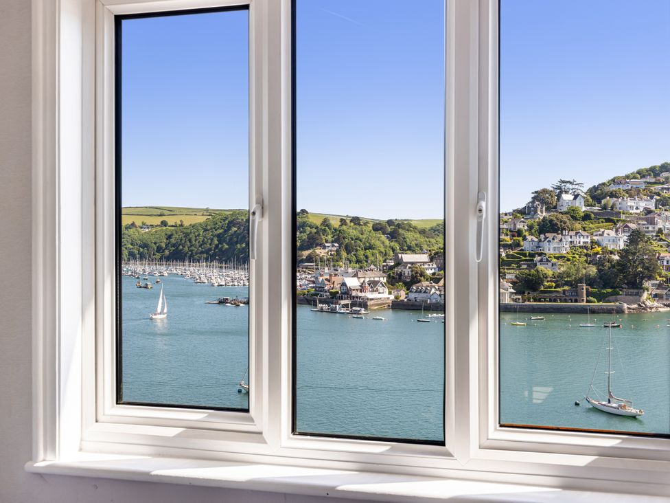 A window view of boats and hills at Bell Cottage in Dartmouth