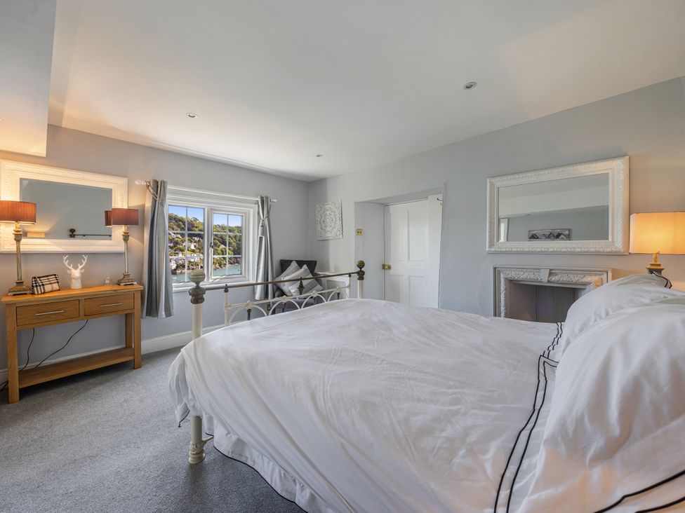 A bedroom with a bed and nightstand at Bell Cottage in Dartmouth