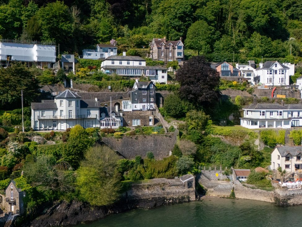 A view of houses on a hillside and water at Bell Cottage in Dartmouth