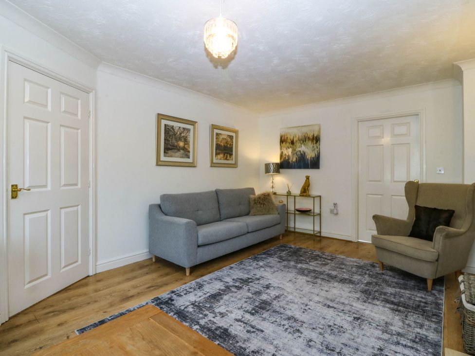 A living room with a sofa and chair at Meadow View in Kinmel Bay