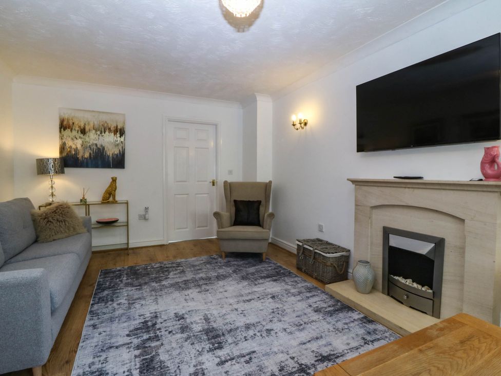 A living room with a sofa and television at Meadow View in Kinmel Bay