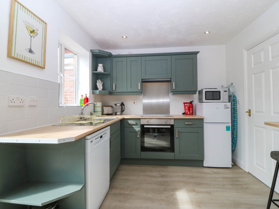 A kitchen with appliances and cabinetry at Meadow View in Kinmel Bay